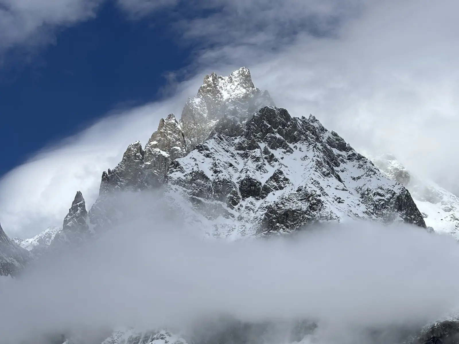 The snowy peaks of the Mont Blanc massif among the clouds