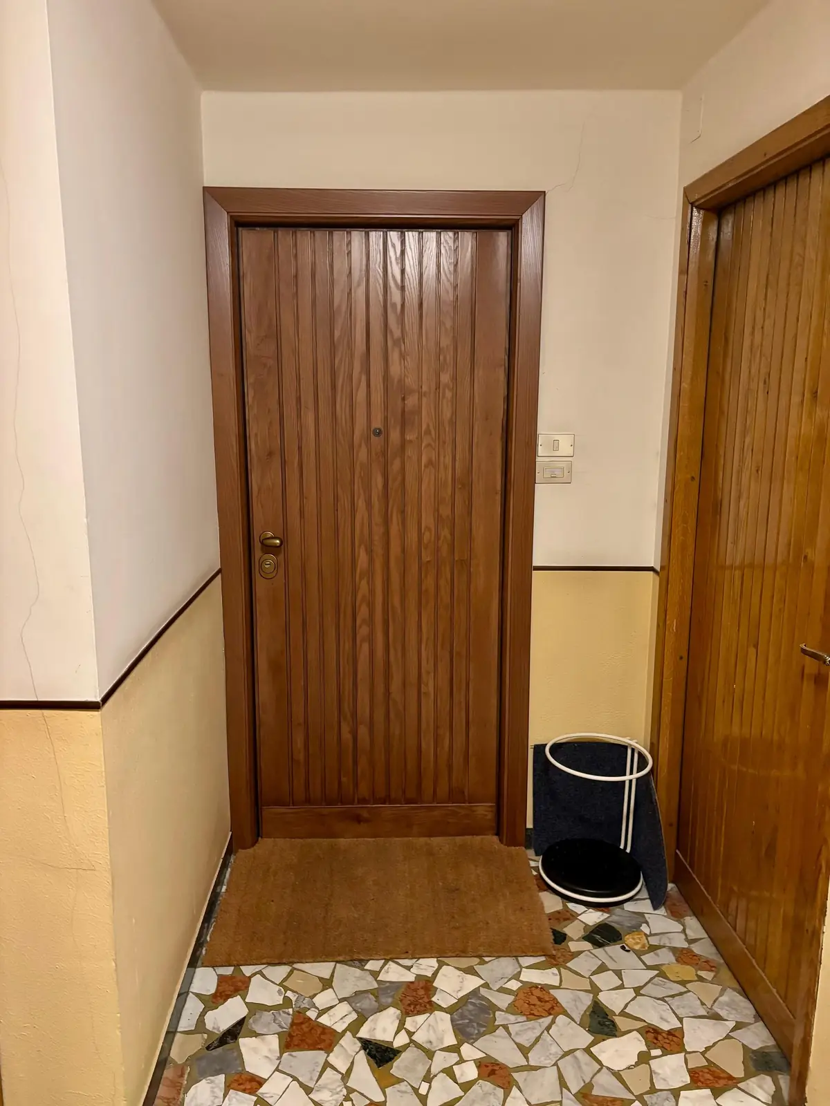 The landing with the wooden front door.
