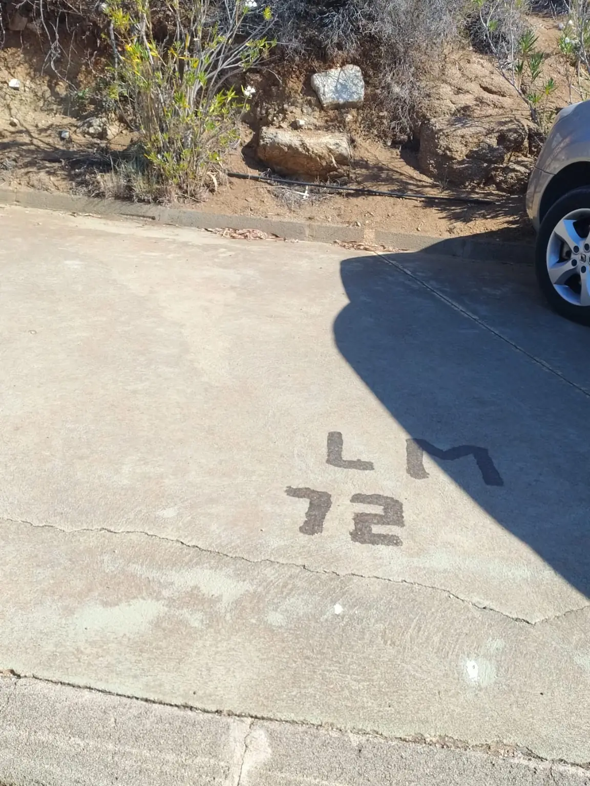 The parking spot with LM 72 painted on the tarmac.